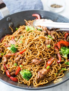 stir fry noodles with beef and broccoli in a skillet