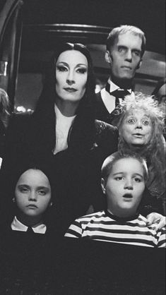 the addams are posing for a photo in front of an audience with their heads turned to look like they're talking