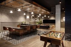 a game room with a foosball table and couches