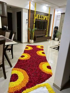 the entrance to a home decorated with flowers and garlands in yellow, red and orange colors