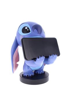 a small toy elephant holding a cell phone in it's trunk and looking at the screen