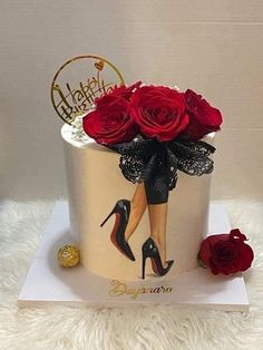 a birthday cake decorated with red roses and high heels