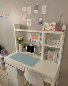 a white desk with a computer on top of it