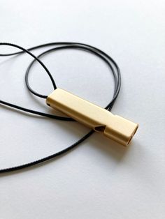 minimalist lightweight to wear slim matte whistle  loud, crisp sound on waxed cotton cord   2.25" x 0.5" pendant 34" cord, preferred length may be specified Emergency Whistle, Emergency Alert, Whistle Necklace, Medical Emergency, Outdoor Survival, Oui Oui, Brass Gold, Emergency Medical, Cotton Cord