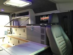 the interior of an rv with desks and cabinets