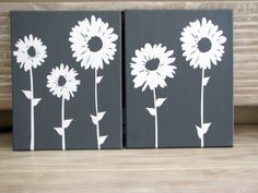 two canvases with white flowers painted on them