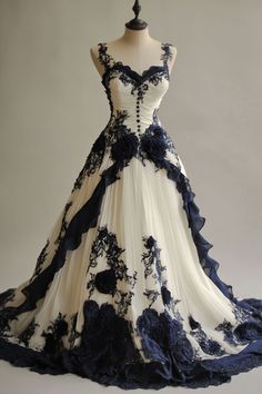 a white and blue wedding dress with black flowers on the bouncy skirt is displayed