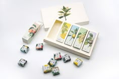 an assortment of teas and boxes on a white surface