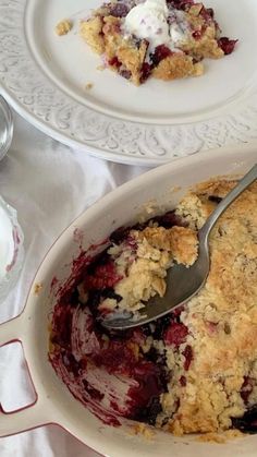 a close up of a pie in a pan on a table with other plates and utensils