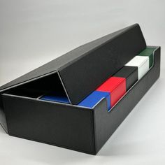 a black box with three different colored folders in the bottom and one red, white, and blue