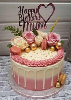 a birthday cake decorated with pink and gold decorations