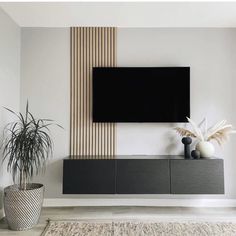 a large flat screen tv mounted to the side of a wall in a living room