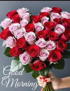 a woman holding a bouquet of roses with the words good morning written in white lettering