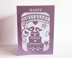 a purple card with an image of a cake on it and the words happy anniversary