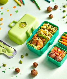 two plastic containers filled with food on top of a table