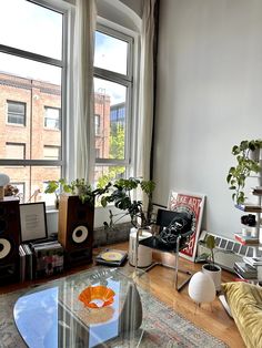 a living room filled with furniture and lots of windows next to a window sill