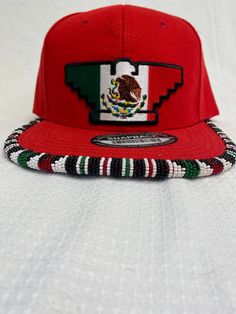 You are viewing a hand-beaded baseball hat with a Mexican Flag Huelga Bird patch. The hat is ADULT size. All beads are sewn by hand.  All patches are applied by hand. No two hats are exactly alike and will never be replicated exactly. Made by an indigenous artist, I am an enrolled member of the Jumano Nation of West Texas. Free shipping to US locations only Bead Hat, Mexican Flag, Mexican Flags, Beaded Hat, Beaded Earrings Patterns, West Texas, Bird Seed, Bead Work Jewelry, Work Jewelry