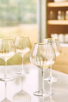 several wine glasses lined up on a table