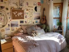 a bed room with a neatly made bed and lots of pictures on the wall