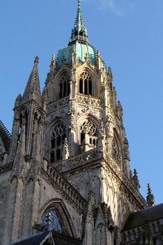 the top of an old building with a clock on it's face and steeple