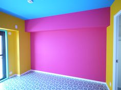 an empty room with colorful walls and flooring