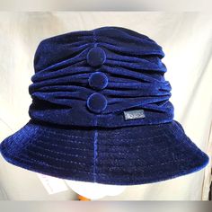 The Graceful Betmar Tanzanite Hat Is A Velvet Ruched Bucket Hat With A Tonal Button Accent And Is A Gorgeous Update To A Timeless Classic Silhouette Brand New With Tags. Blue Wide Brim Cloche Hat, Blue Fitted Wide Brim Cloche Hat, Blue Winter Bucket Hat With Curved Brim, Blue Cloche Hat With Curved Brim, Blue Wide Brim Bucket Hat One Size, Blue Wide Brim Hat One Size, Fitted Blue Cloche Hat For Winter, Blue Adjustable Cloche Hat, Adjustable Blue Cloche Hat