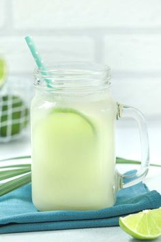 a green drink in a mason jar with a straw