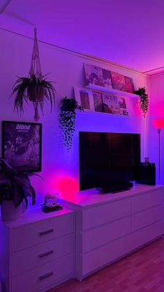 a living room filled with furniture and purple lighting on the wall above it is a flat screen tv