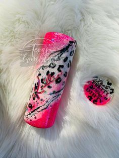 the pink and black nail polish is on top of white fur