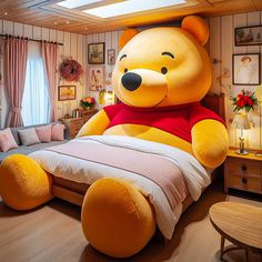 a large teddy bear sitting on top of a bed in a bedroom next to a couch