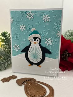 a penguin with a hat and scarf on it's head is standing in front of some snowflakes