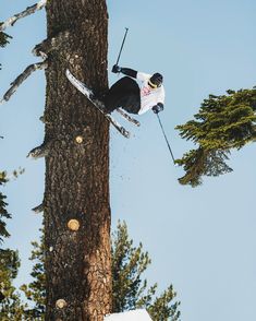 a man flying through the air while riding skis