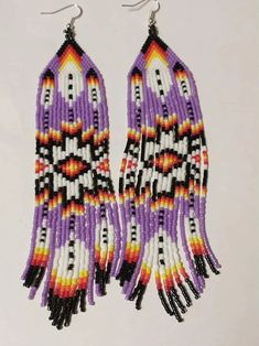 two pairs of beaded earrings with fringes and beads in purple, orange, yellow and white colors