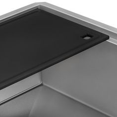 a black tray on the side of a stainless steel sink