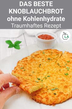 a person holding a piece of cheese pizza on top of a white plate with sauce in the background