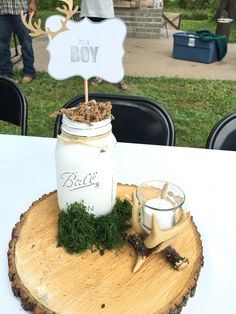 there is a mason jar with moss on it and a sign that says the boy