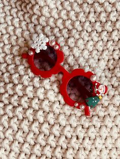 These toddler Christmas sunglasses are cute and trendy! With many Christmas charm options available these are sure to make a great stocking stuffer. Perfect for a gift, party favors, or cute for your little ones to wear. This listing is for one pair of sunglasses. If you would like more, please add into the same cart and check out in one order. *MATERIAL* These are very lightweight plastic with beads attached using an extra strength bonding adhesive. Never leave children alone with sunglasses as small pieces could break off and become a choking hazard. Do not let your child put the sunglasses in their mouth. All Christmas sunglasses will include one snowflake and 6 pearls. 2 Christmas charms will be selected based on availability. If you have a preference of charms please specify in the pe Cheap Novelty Sunglasses For Gifts, Playful Plastic Sunglasses For Gift, Cheap Heart-shaped Sunglasses For Gifts, Christmas Sunglasses, Personalized Kids Sunglasses, Sunglasses Cute, Personalized Sunglasses, Valentines Bracelets, Wood Bead Bracelet