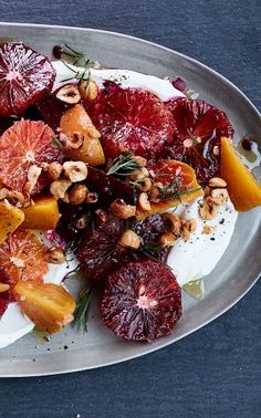 a white plate topped with fruit and nuts