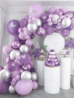 purple and silver balloons are on display at a baby's first birthday party in a box