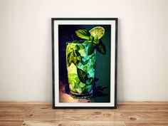 a framed photograph of a green drink with limes and mints on the rim