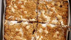 a close up of a cake in a pan with white icing on the top