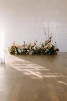 an arrangement of flowers is arranged on the floor