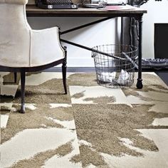 a white chair sitting on top of a rug next to a desk