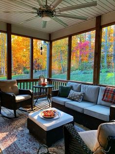 a covered porch with couches and chairs on it