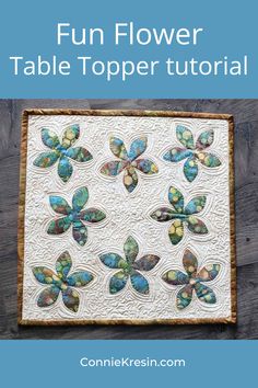 a quilted table topper with butterflies on it and the words fun flower table topper