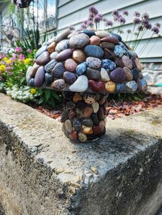 a mushroom made out of rocks sitting on top of a cement block