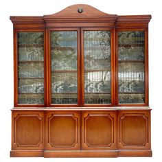 an old wooden cabinet with glass doors