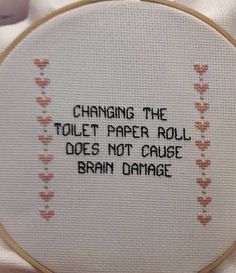 a cross stitch quote on a white cloth