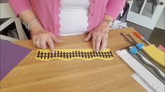 a woman is making a train track out of construction paper