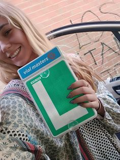 a woman holding up a green and white sign